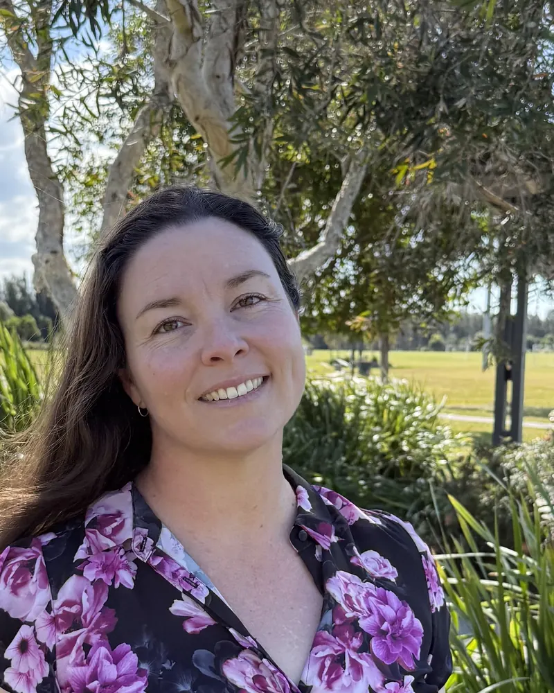 Leia Wilton, speech pathologist, smiling outdoors