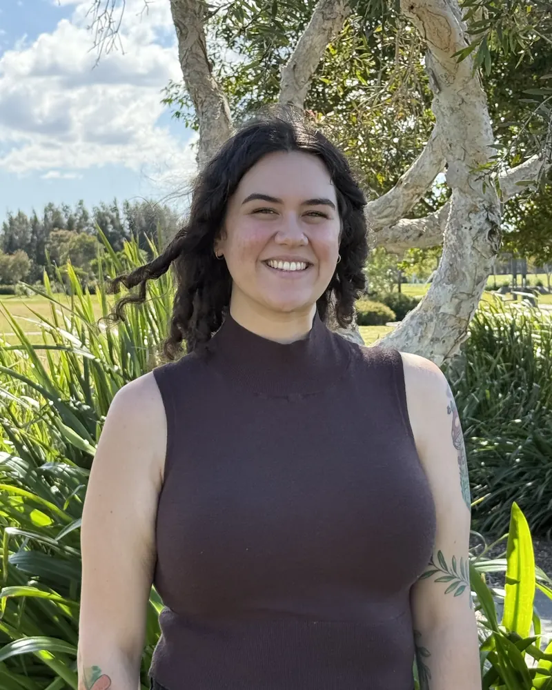 Steph, speech pathologist, smiling outdoors